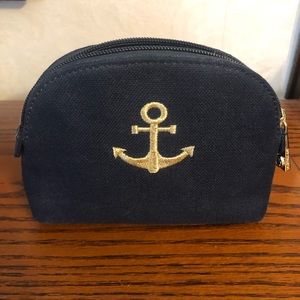 Small zipper pouch with gold stitched anchor.